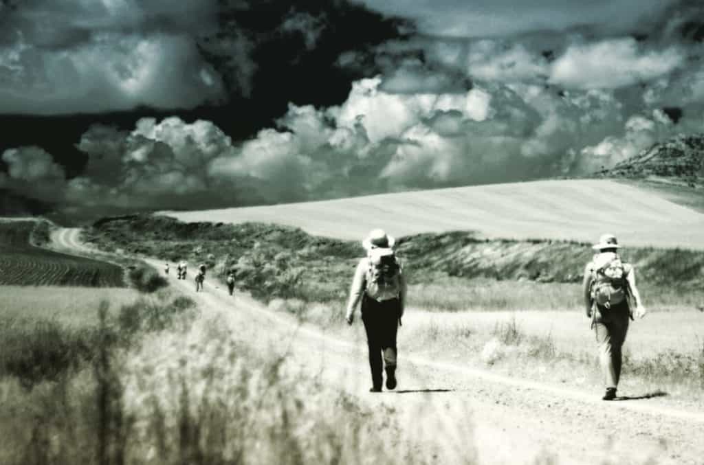 walking the el camino trail with clouds in the background black and white photo