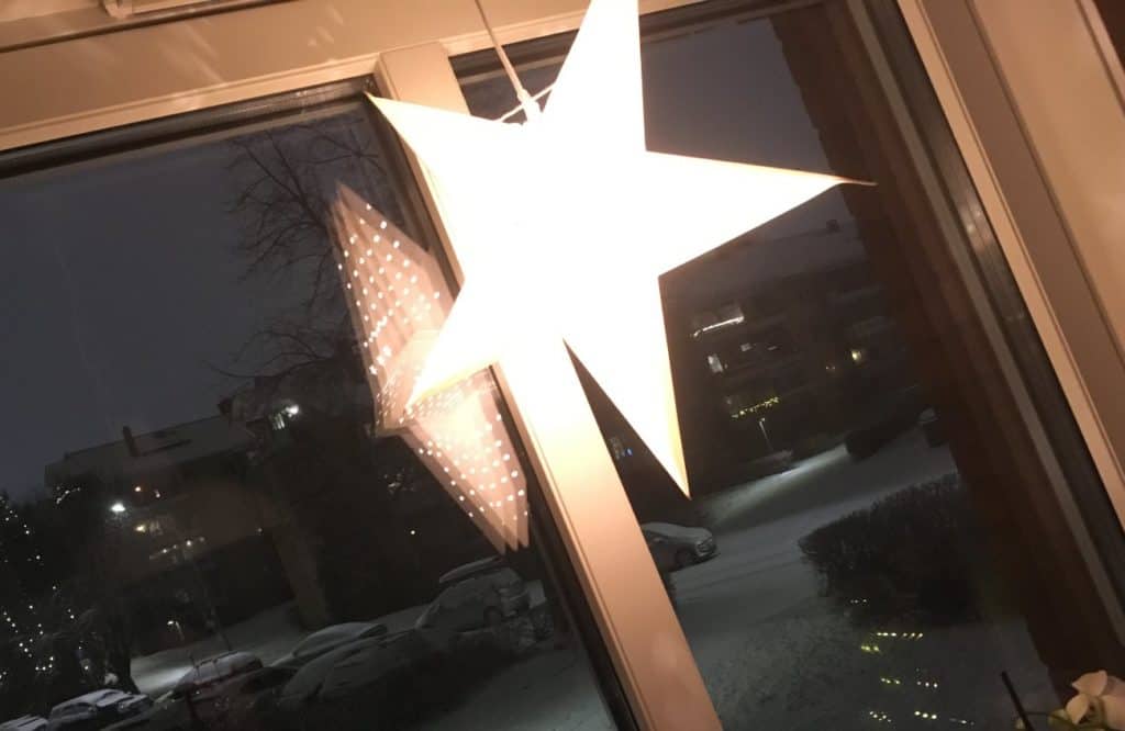 Traditional white star hanging in the window for Norwegian Christmas