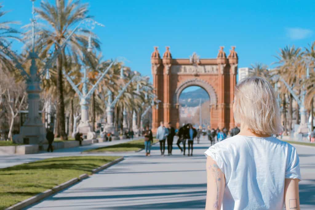 traveler standing near arch in Barcelona