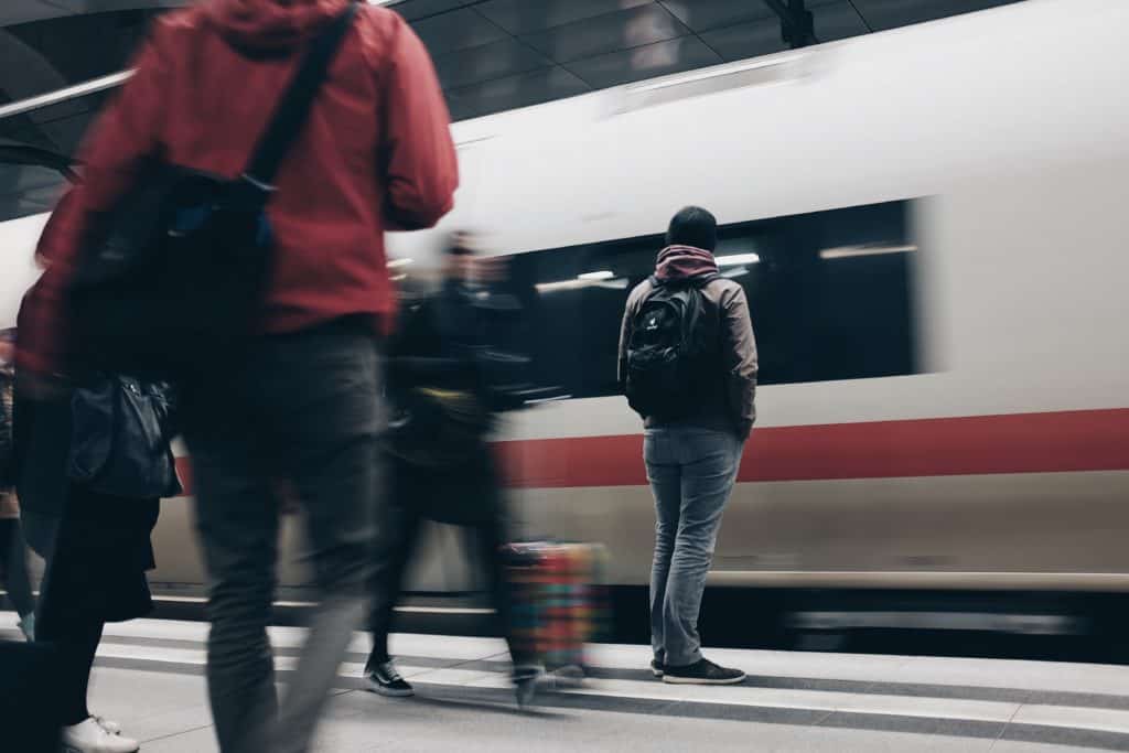 travelers on the platform as the train pulls in